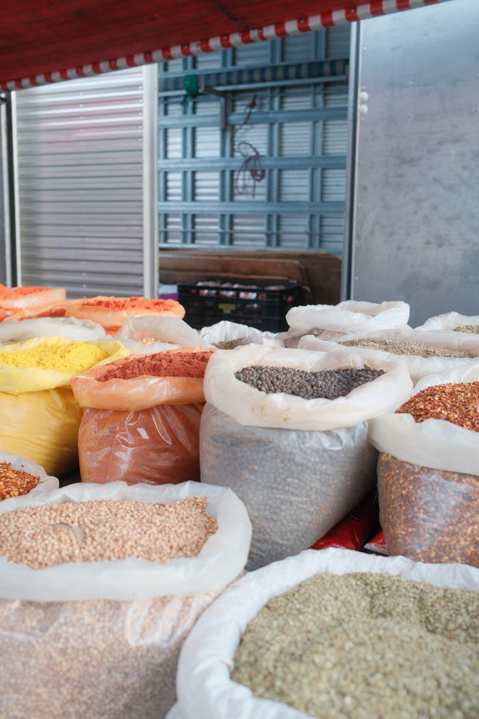 why-choose-us Close-up of various spices in sacks on a market stall, showcasing vibrant colors and textures.